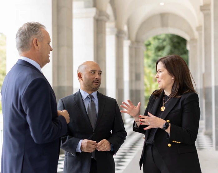 Capitol Advocacy lobbyists conversing in the hall of the California State Capitol